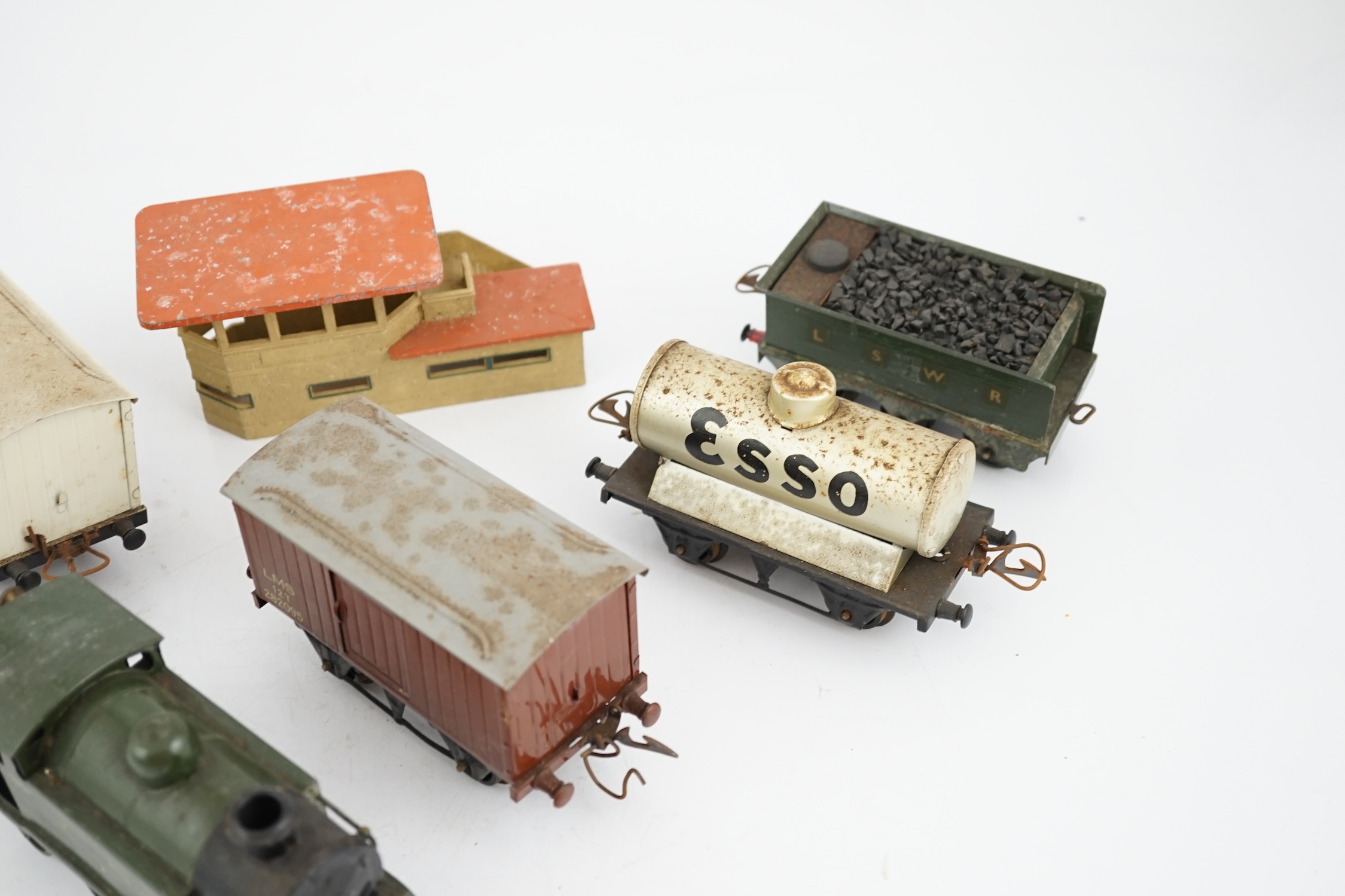 Fourteen 0 gauge tinplate etc. railway items, including three clockwork locomotives; an LSWR 4-4-0 tender loco, an SR 0-4-4T loco and an SR 0-4-2T loco, together with nine Hornby freight wagons, a Bing milk traffic van a